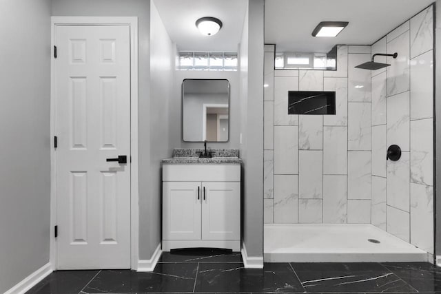 bathroom with vanity and tiled shower