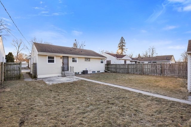 rear view of house featuring a yard and central AC unit