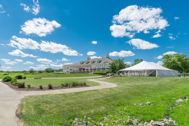 view of property's community with a lawn