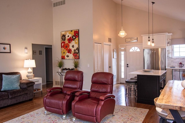 living room featuring vaulted ceiling and dark wood-type flooring