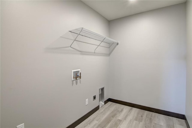 clothes washing area with washer hookup, hookup for an electric dryer, and light wood-type flooring