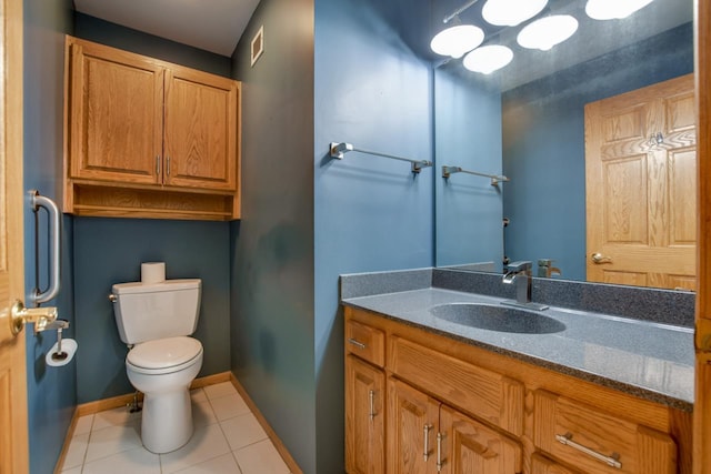 bathroom featuring vanity, tile patterned floors, and toilet