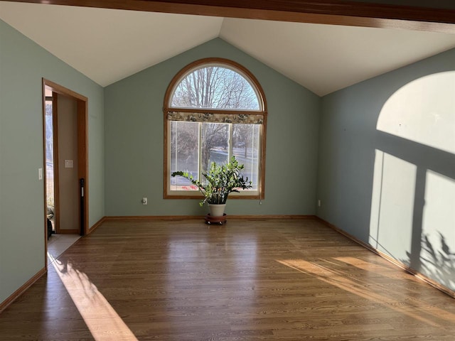 unfurnished room featuring dark hardwood / wood-style flooring and vaulted ceiling