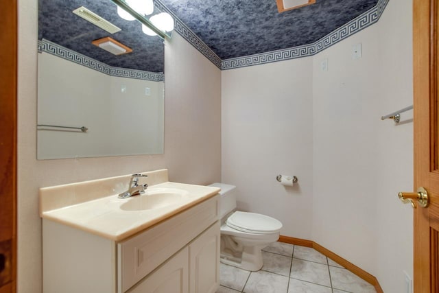 bathroom featuring vanity, tile patterned floors, and toilet