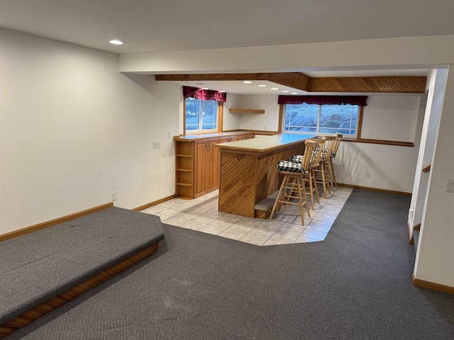 bar featuring light carpet and beamed ceiling