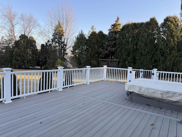 wooden deck with a covered hot tub