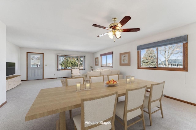 carpeted dining area featuring ceiling fan