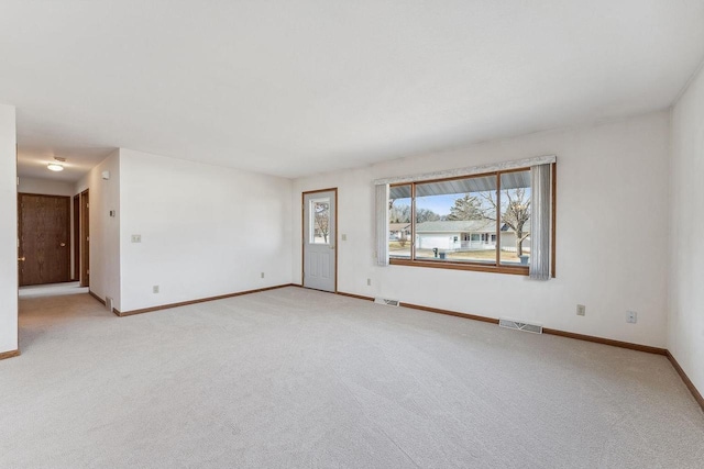 unfurnished room featuring light colored carpet