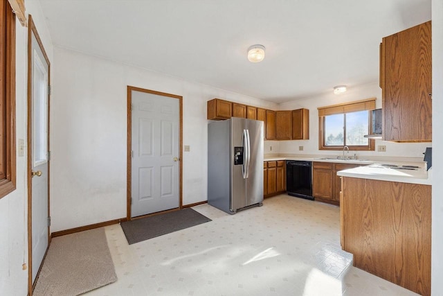 kitchen with stainless steel refrigerator with ice dispenser, dishwasher, and sink