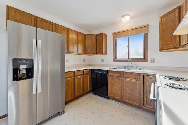 kitchen featuring dishwasher, sink, white electric range, and stainless steel fridge