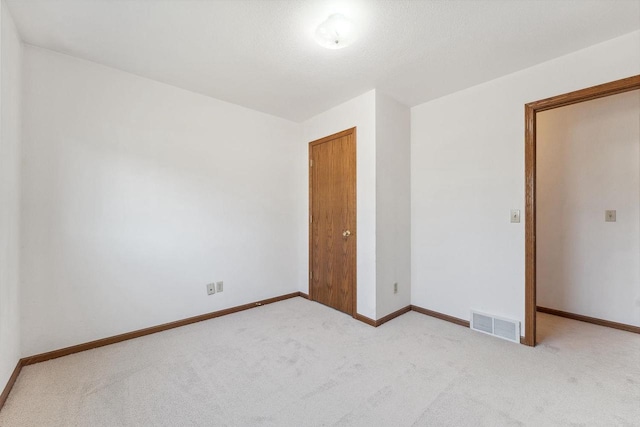 unfurnished room with light colored carpet