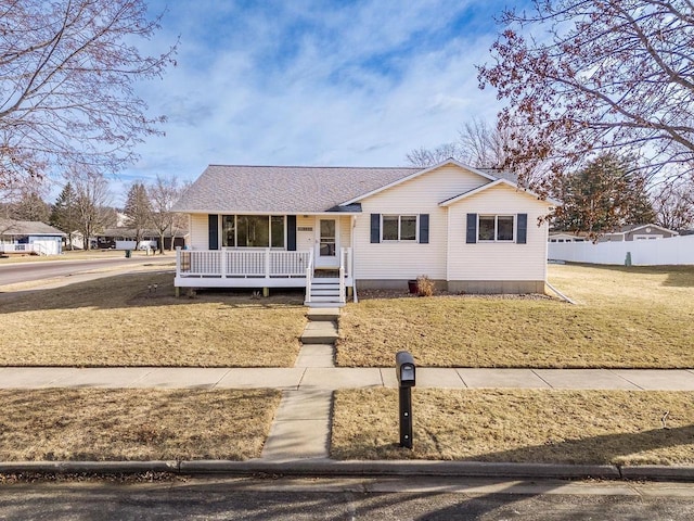 ranch-style house with covered porch and a front lawn