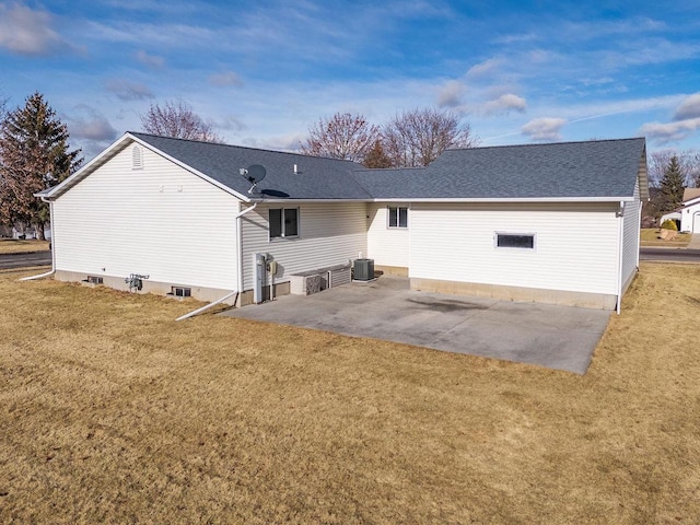 rear view of house with a lawn, central AC unit, and a patio area