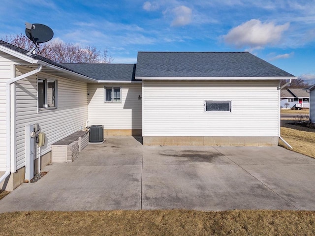 view of side of property featuring central AC unit and a patio