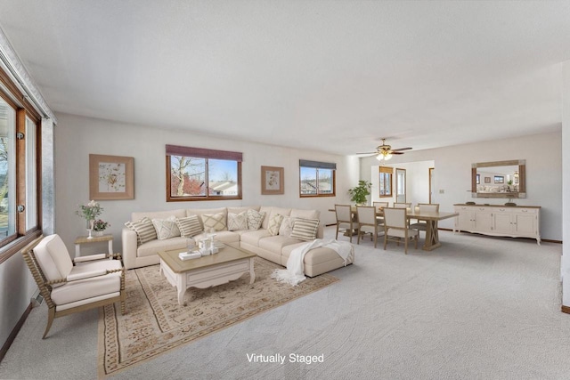 carpeted living room featuring ceiling fan