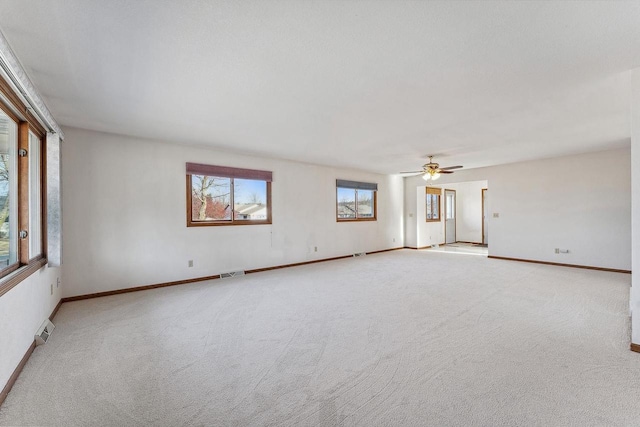 carpeted spare room featuring ceiling fan