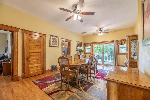 dining area with ceiling fan and light wood-type flooring