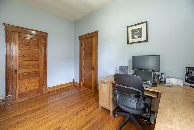 office with light hardwood / wood-style floors