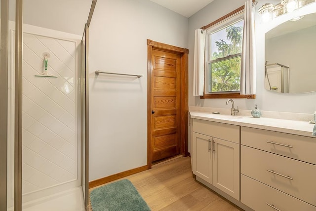 bathroom with vanity, wood-type flooring, and a shower with door