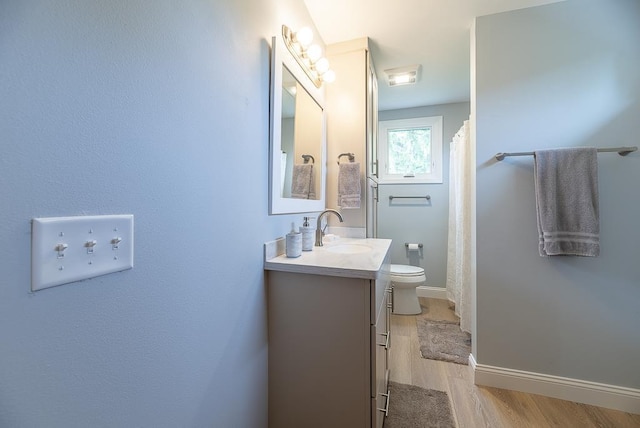 bathroom with vanity, hardwood / wood-style floors, toilet, and a shower with shower curtain