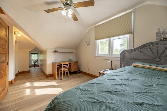 bedroom featuring ceiling fan, lofted ceiling, light hardwood / wood-style floors, and multiple windows