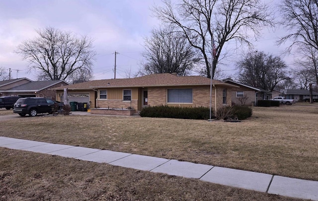 ranch-style house with a garage and a front yard