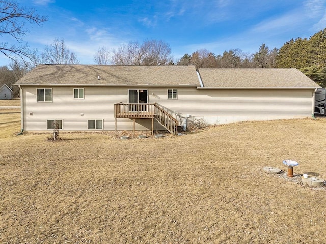 back of property featuring a yard and a deck