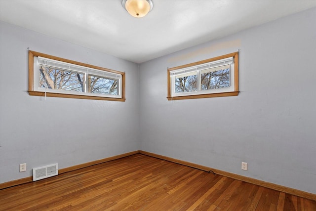 spare room featuring plenty of natural light and light hardwood / wood-style flooring