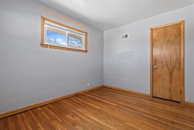 spare room with wood-type flooring