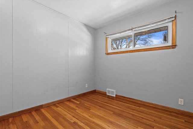 spare room with hardwood / wood-style floors