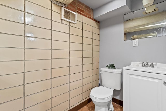 bathroom featuring vanity, toilet, and tile patterned flooring