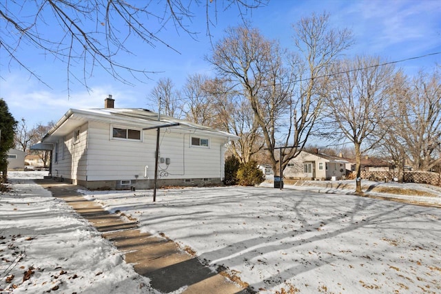 view of snow covered rear of property