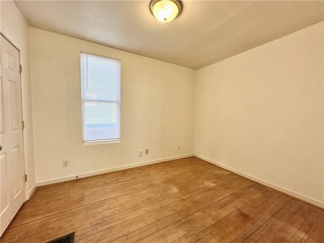 spare room featuring light wood-type flooring