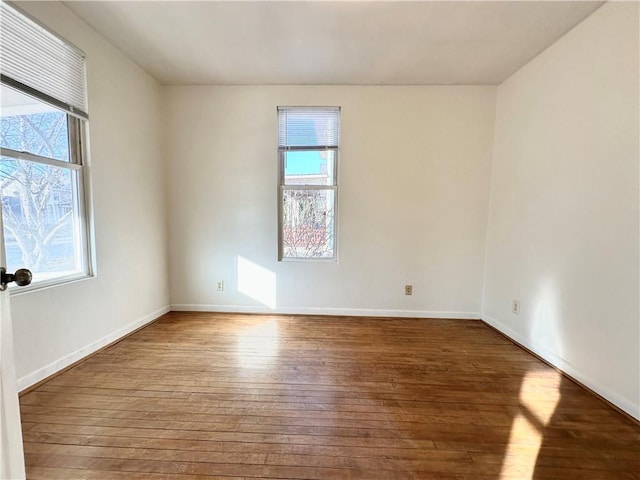 unfurnished room featuring hardwood / wood-style flooring and plenty of natural light