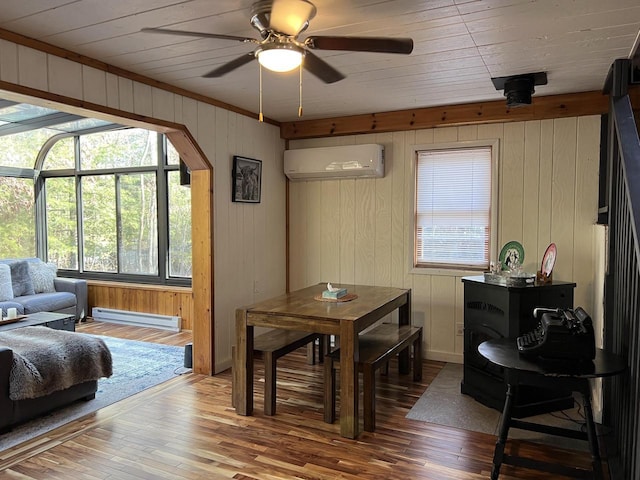 dining room with ceiling fan, a wall mounted AC, baseboard heating, and light hardwood / wood-style floors