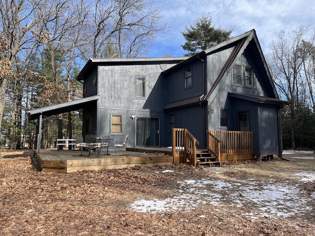 back of property featuring a deck