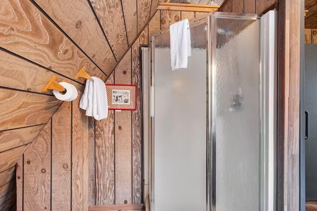 bathroom featuring vaulted ceiling and walk in shower