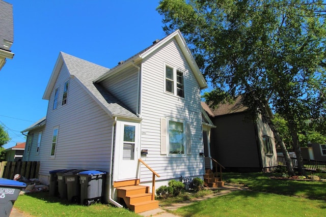 rear view of property with a lawn