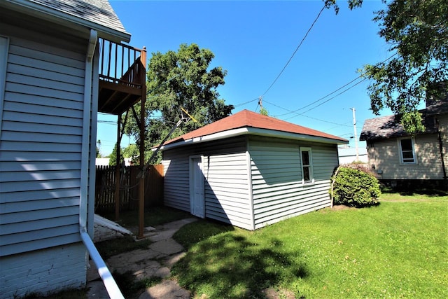 view of side of property with a yard and an outbuilding