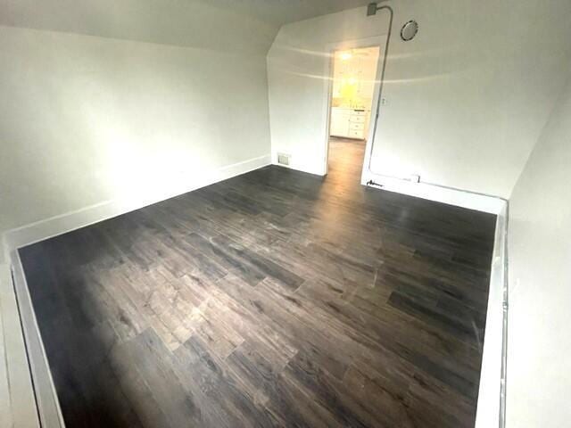 spare room with dark hardwood / wood-style flooring