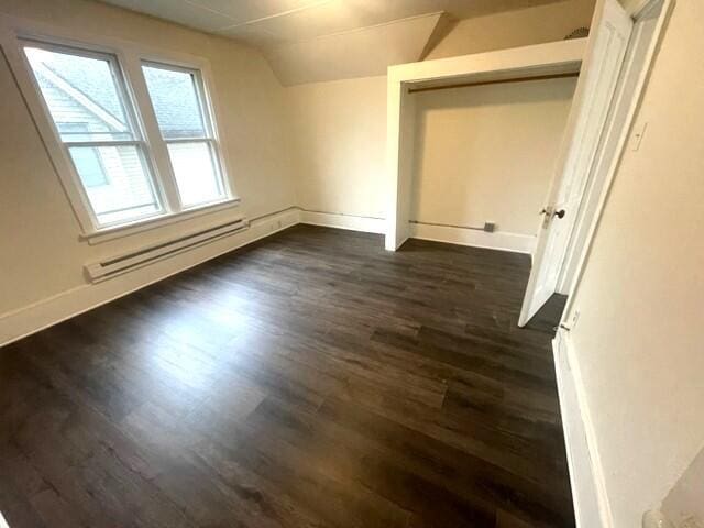 bonus room with dark hardwood / wood-style flooring, lofted ceiling, and baseboard heating