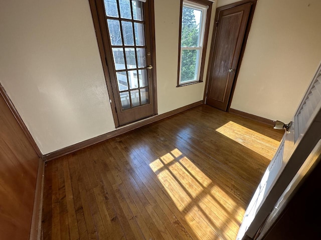 empty room with dark wood-type flooring