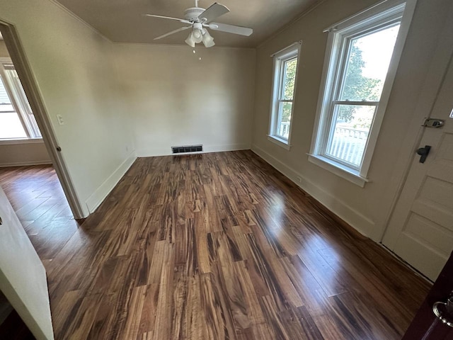 empty room featuring ceiling fan and dark hardwood / wood-style floors