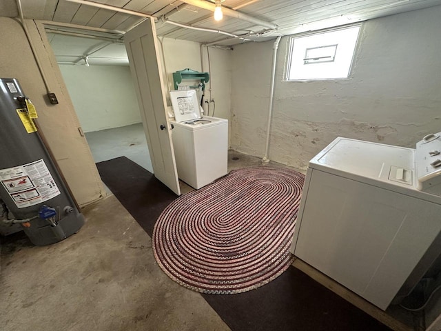 washroom featuring water heater and independent washer and dryer