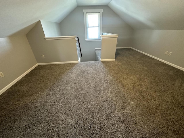 additional living space featuring lofted ceiling and carpet floors