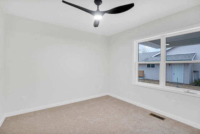 carpeted empty room featuring ceiling fan