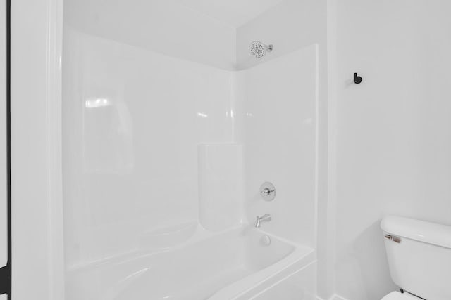 bathroom with bathtub / shower combination and toilet