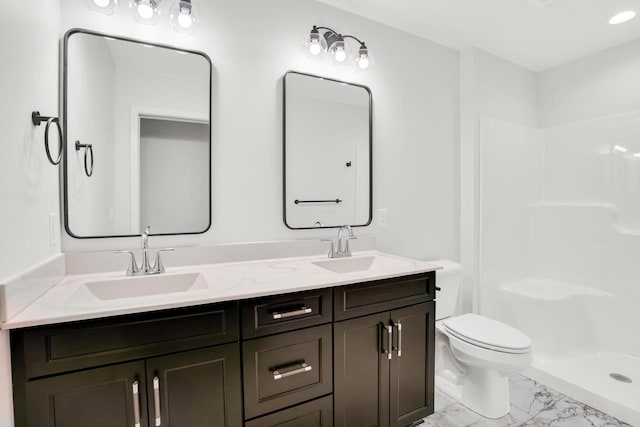 bathroom featuring toilet, vanity, and walk in shower