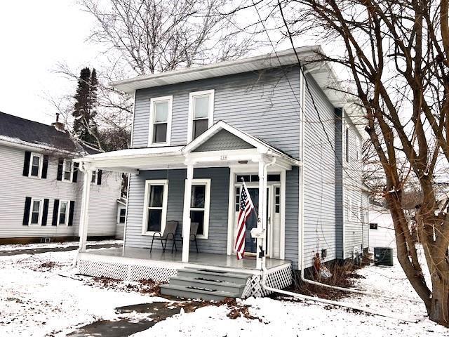 view of front property with central AC and covered porch