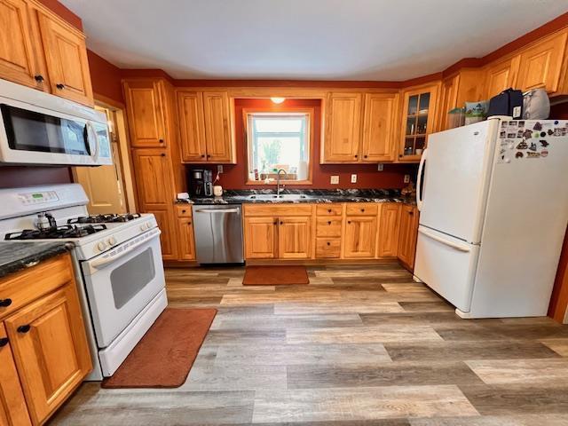 kitchen featuring sink, white appliances, and light hardwood / wood-style floors